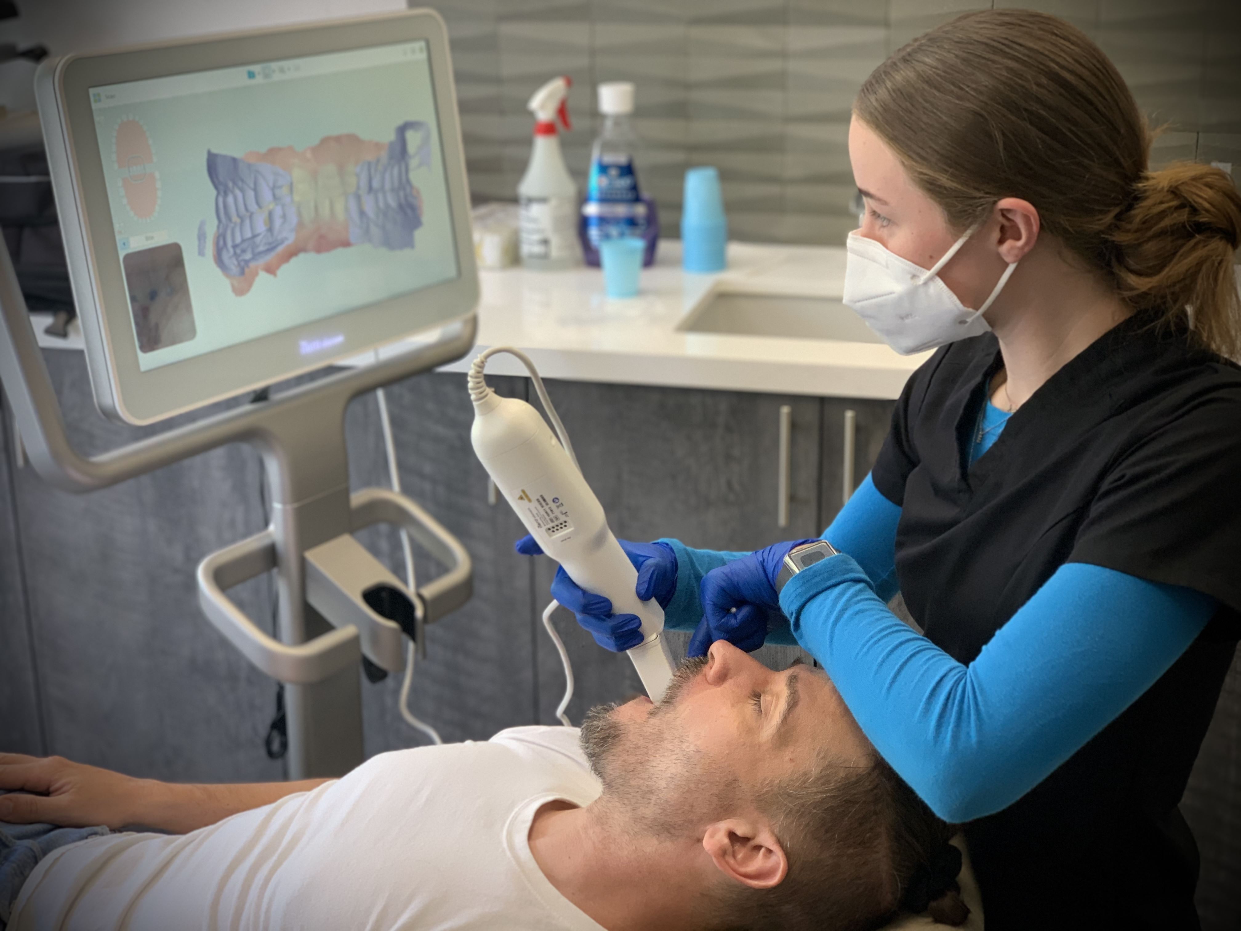 Dentist scanning teeth alignment